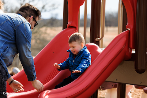 A father and son play on the slides at the woolaroc playground