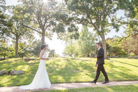 A bride and groom walking toward each other during their wedding at Woolaroc
