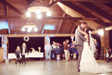 Newly married couple dancing together in the pavilion by Clyde Lake
