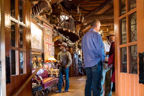 Guests looking at the artifacts at the lodge during an event at Woolaroc
